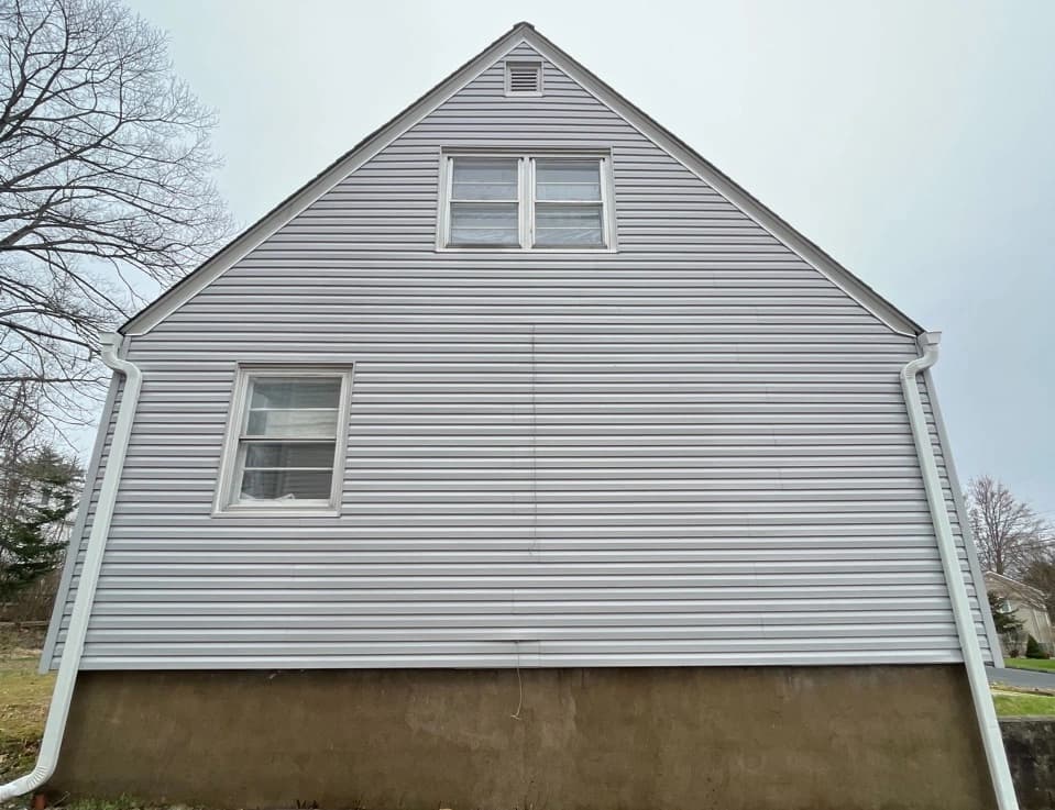 Avon Power Washing technician performing detailed house washing in Avon residential area