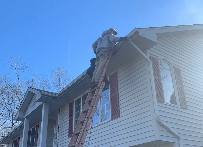 Gutter cleaning and maintenance being performed by Avon Power Washing in Avon